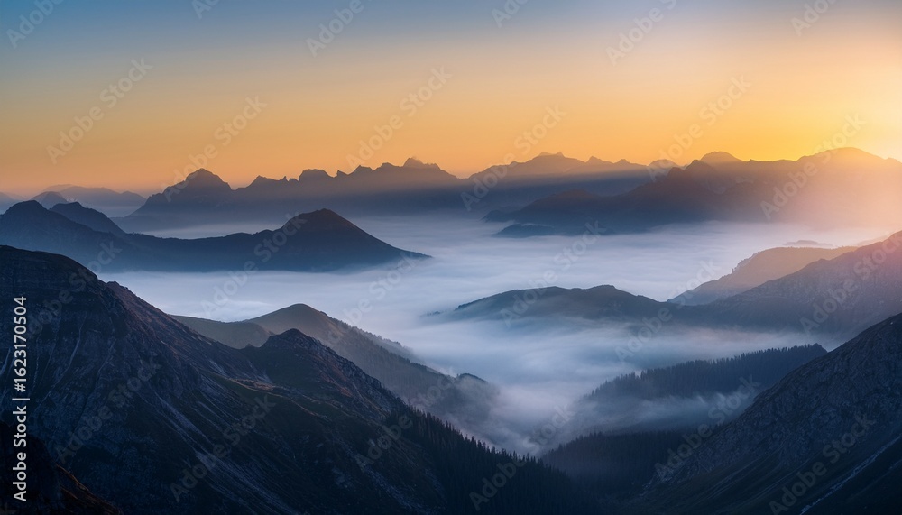Obraz premium a misty mountain range at dawn with the sun peeking through the clouds