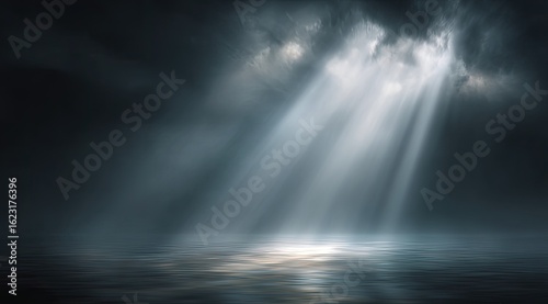 Dramatic, ethereal scene of light beams piercing dark clouds over a calm body of water