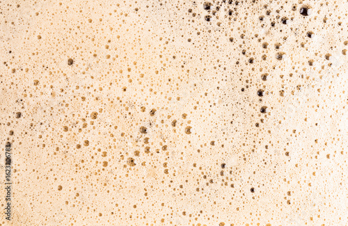Macro view of frothy coffee foam texture in detail
