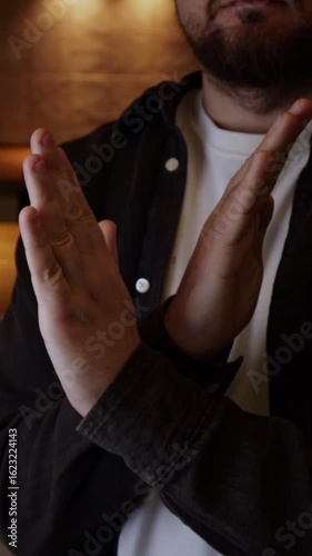 Man's hands crossed demonstrating a gesture of prohibition, denial, disagreement, warning. X sign