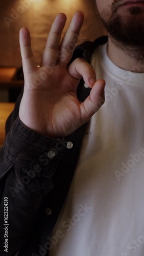 Man showing OK hand gesture demostration approval, recommendation, positive attitude and success