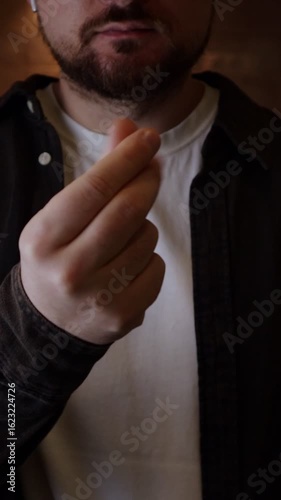 Man making money gesture. Man demands money with hands. Businessman show with hand gesture that it's gonna cost
