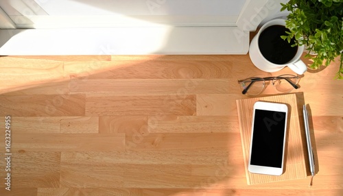 Minimalist Workspace Flat Lay With Coffee Plant Smartphone Glasses Notepad On Smooth Wooden Surface