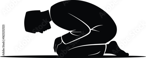 Silhouette of a person kneeling with head bowed in prayer or meditation