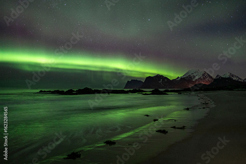northern lights above beach 