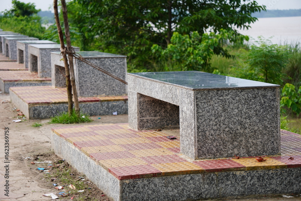 Obraz na plátně series of granite benches and tables, commonly found in public spaces like parks or riverfronts