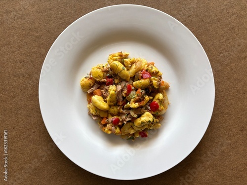 Cooked Ackee and Vegetables in A White Plate. Top View of Jamaican Food.