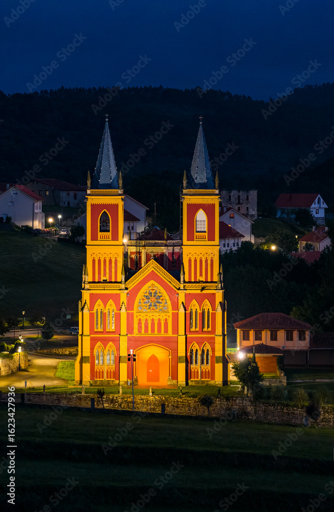 Fototapeta premium Aerial view from a drone of the neo-Gothic Church of San Pedro Ad Enlace in the town of Cóbreces, in the municipality of Alfoz de Loredo. Cóbreces, Cantabria, Spain, Europe