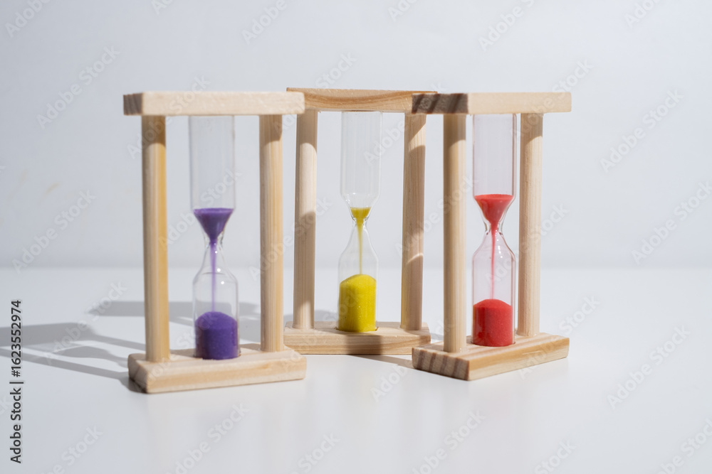 Fototapeta premium Hourglass on a colored background with space for text. Concept of lack of time and deadline.
