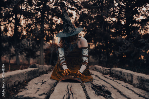 Photos Witch performs ritual in the woods