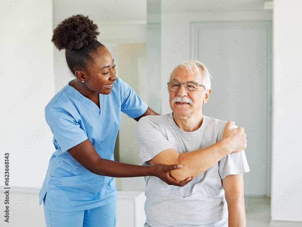 Obraz premium Doctor or nurse or physiotherapist caregiver exercise with senior man at clinic or nursing home