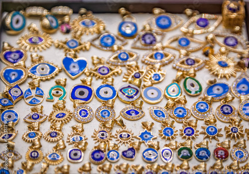 Canvas Print Gold jewelry with evil eye or nazar charms, Egyptian Bazaar in Istanbul, Turkey