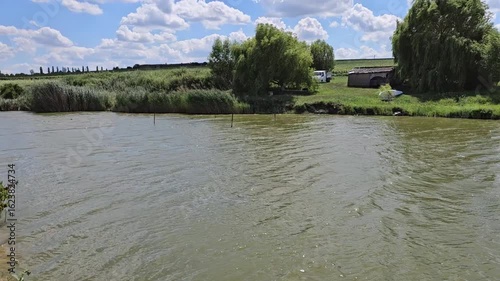 A body of water with trees in the background