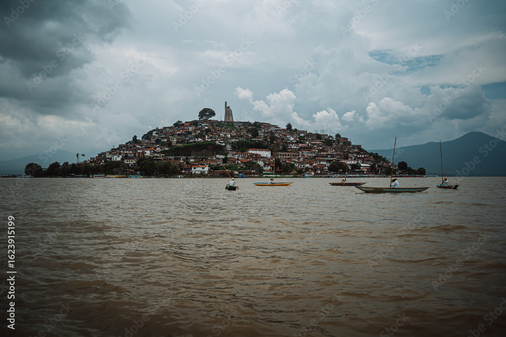 Naklejka premium Janitzio Island in Lake Patzcuaro, Mexico, with traditional fishermen fishing.