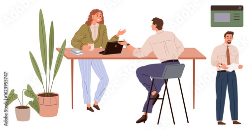 Two colleagues discussing projects at a desk with a laptop, potted plants, and coffee. A third colleague reads a document nearby. Ideal for teamwork, collaboration, office culture, communication