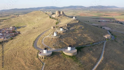 Aerial view of sunrise over the Medieval Castle of Consuegra and his windmills in Toledo, Spain.