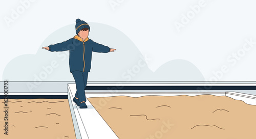 Young Boy Balances Along Edge Of Sandpit Playing In Winter Clothing