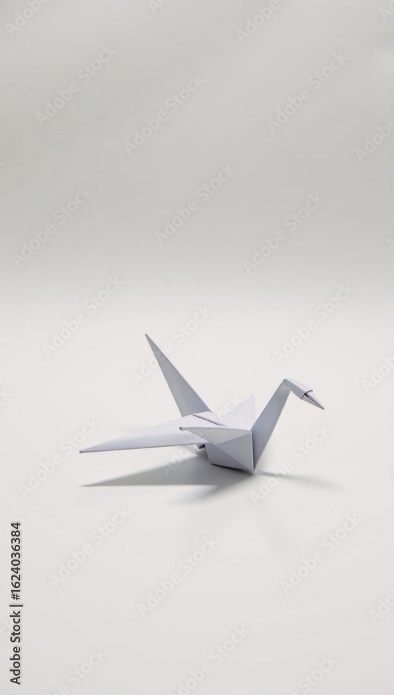 Origami-style white background features a paper crane bird in flight Origami-style white background features a paper crane bird in flight