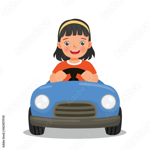 Little girl driving toy car having fun outdoor