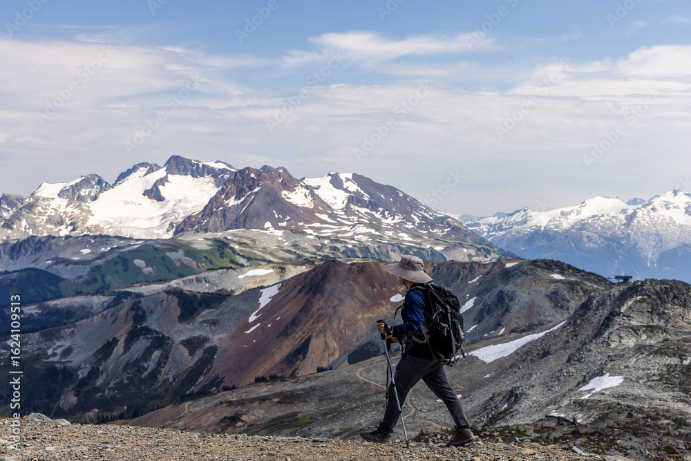 Fototapeta premium Hiker Exploring Scenic Mountain Trail in Whistler, BC with Stunning Peaks
