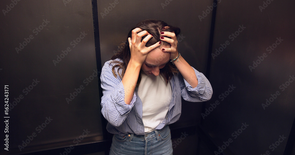 Fotografie Female Elevator Technician Comforts Woman Trapped