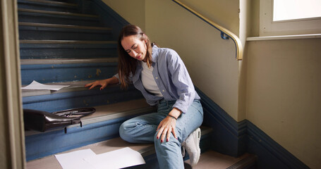 Injured Woman Sitting On Staircase After Slip And Fall Accident