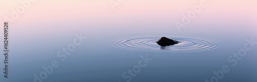 serene lake scene dawn featuring water surface reflecting soft pink sky delicate ripples disturbing