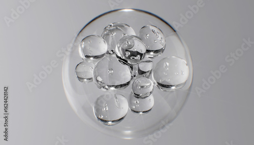 Fotografía Abstract cosmetic background with glass spheres and bubbles inside a larger orb