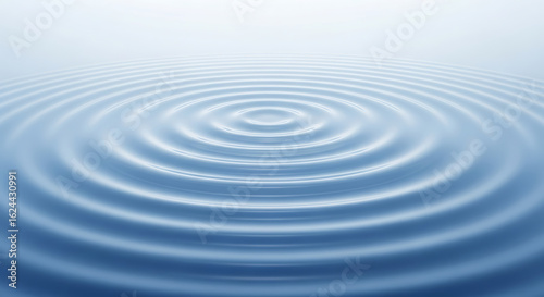 Calm blue water with concentric circles rippling outward from a central point.