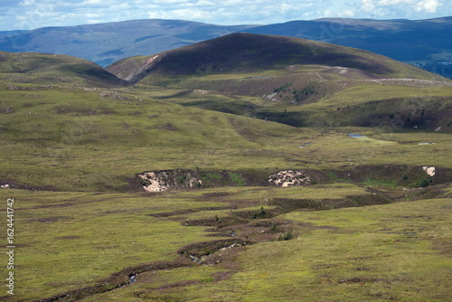 Well-trodden path through mountainous region in Scotland Cairngorms