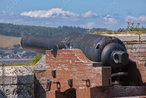 Fort canon artillery aimed out into a river