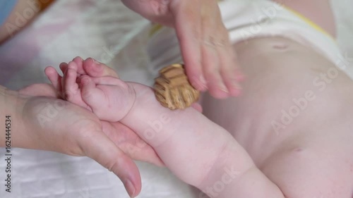 Wallpaper Mural Infant sensory massage with a juniper wood ball to stimulate tactile development. Gentle therapy for babies under one year old Torontodigital.ca