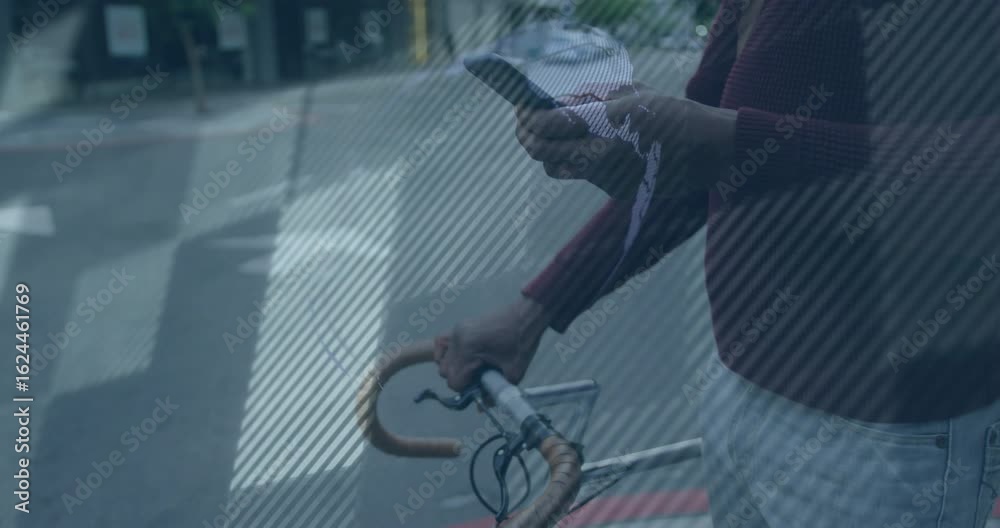 Man tapping smartphone beside bike as 3D globe appearing then fragmenting in technology demo