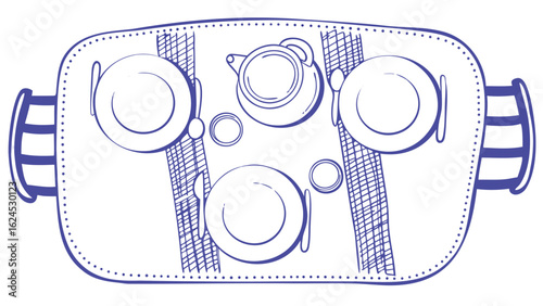 Overhead view of a table setting with plates teapot and cutlery on a tray with handles and placemats