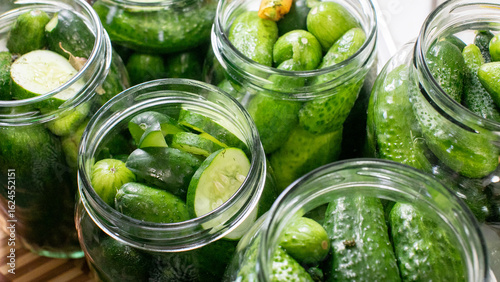 Fényképezés Crisp cucumbers dance in briny aquariums, evoking pickle perfection for National