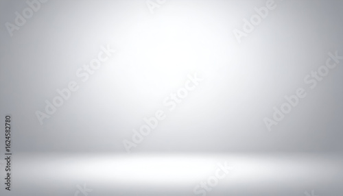 Fototapeta Naklejka Na Ścianę i Meble -  Bright Spotlight Illuminating an Empty, Seamless Gray Studio Room Background.