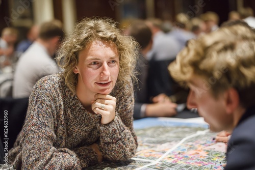 Engaging discussion between individuals at a networking event focused on city planning and urban development