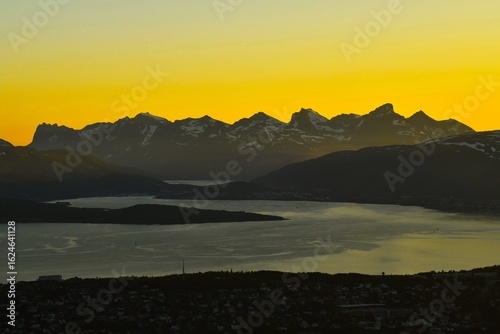 Mountain panorama west of Tromsøya island (with Skittentinden and Store Blamann massif) lit by the midnight sun (polar day) as viewed from the lookout near Storsteinen (Troms county, Northern Norway)