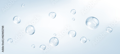 Transparent drops isolated on light blue background. Clear bubbles design elements.