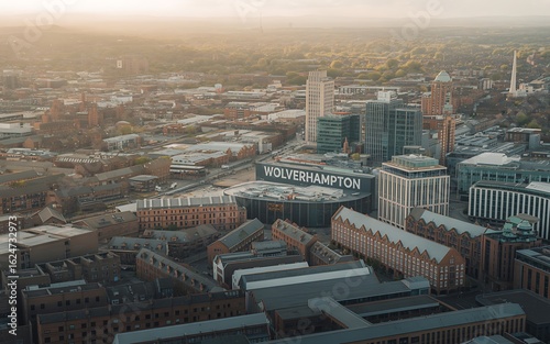 Aerial view of Wolverhampton city center with the Molineux Stadium illuminated by the golden hour sun