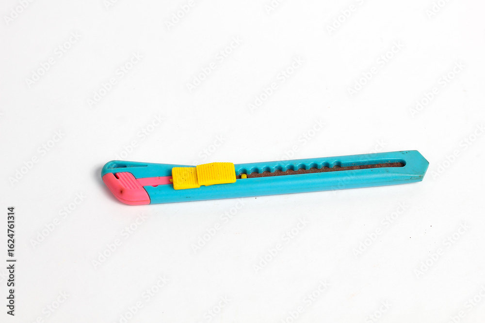 blue box cutter ready for art projects or office tasks on bright white backdrop close up blue box cutter ready for art projects or office tasks on bright white backdrop close up
