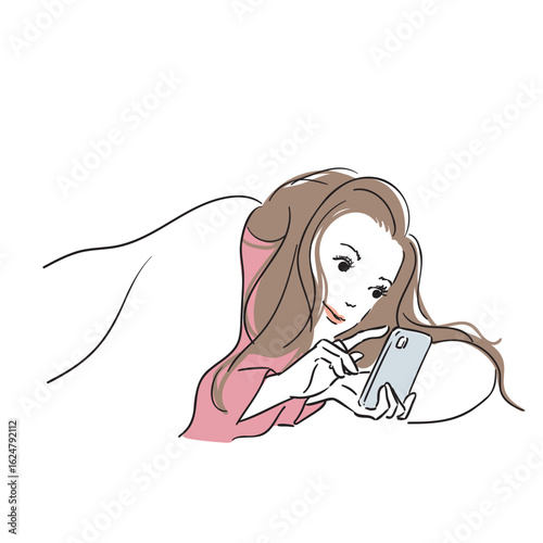 布団の中でスマホを触る女性