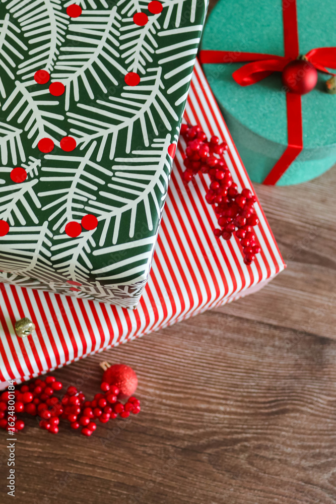 Fototapeta premium Close-up of Christmas gifts with red berries