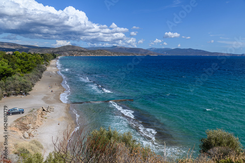 Fototapeta Naklejka Na Ścianę i Meble -  Paralia Kastraki Beach in Asini – Tranquil Shoreline Near Ancient Ruins in Tolo, Greece