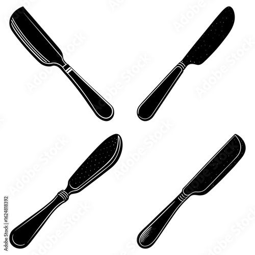 Four black and white butter knives arranged in a square pattern on a white background isolated view