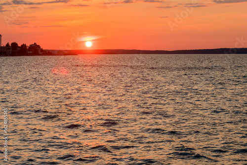 Landscape of the evening sunset against the background of the waters of the large Onega Lake.