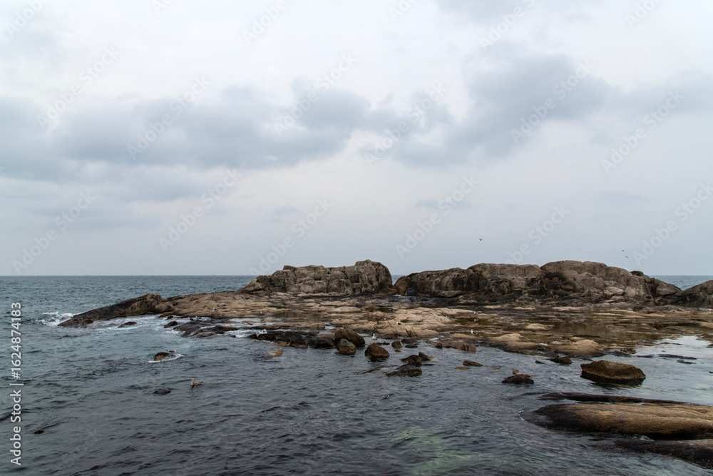 rocky beach and sea on the cloudy day rocky beach and sea on the cloudy day