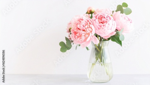 Wallpaper Mural Bouquet of pink peonies in a clear glass vase with green foliage, set against a white backdrop—soft, elegant, and serene. Torontodigital.ca