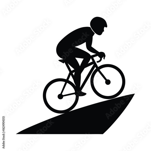 Silhouette of cyclist ascending steep incline