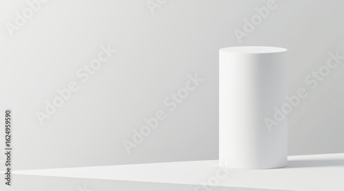Minimalist white cylinder pedestal with soft shadow on a white background